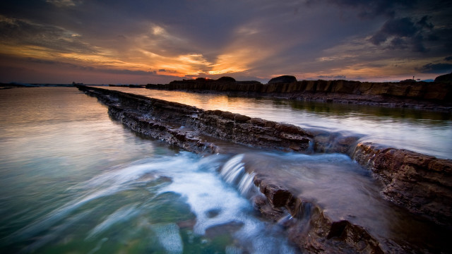 Sunset water rocks wave cityscape free wallpaper - medium preview image