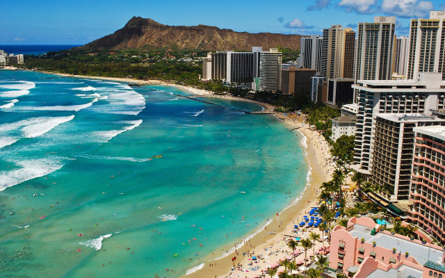 Beach crowd buildings mountain distance free wallpaper - medium preview image