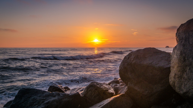 Sunset ocean rocks waves person #2 free wallpaper - medium preview image