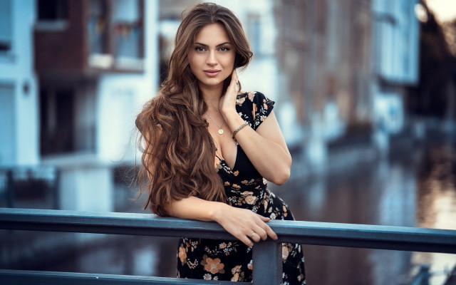 Woman leaning on rail serious #2 free wallpaper - medium preview image