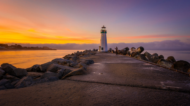 Lighthouse pier sunset clouds water free wallpaper - medium preview image