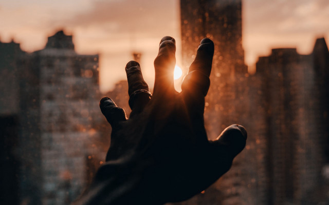 Hand reaching sun city blurry free wallpaper - medium preview image