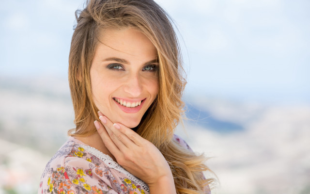 Woman smiling mountain blue sky free wallpaper - medium preview image