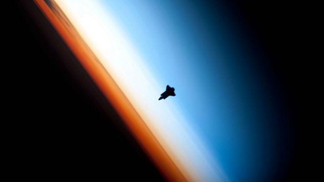 Bird flying over earth horizon free wallpaper - medium preview image