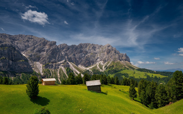 Grassy field cabins mountains clouds free wallpaper - medium preview image