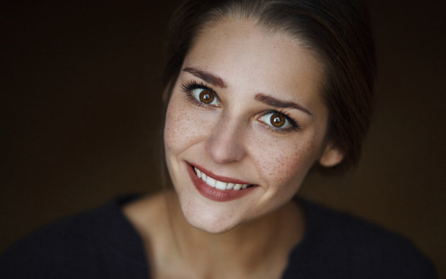 Freckled woman smiling realistic portrait free wallpaper - medium preview image