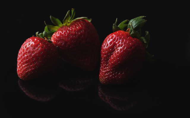 Three strawberries black surface reflection free wallpaper - medium preview image
