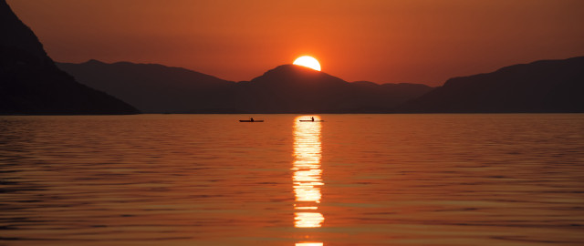 Boat sunset mountains person water free wallpaper for desktop - medium preview image