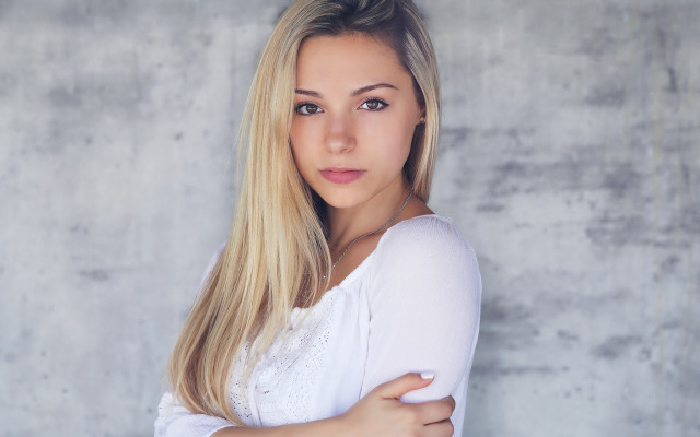 Blonde woman crossed arms concrete free wallpaper - medium preview image
