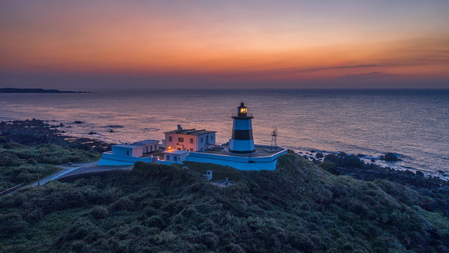 Lighthouse hill ocean sunset beach free wallpaper - medium preview image