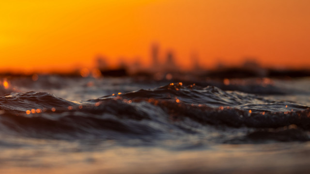Blurry city skyline sunset waves free wallpaper - medium preview image