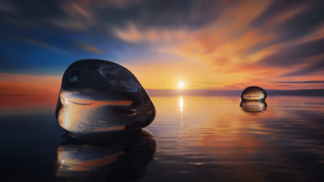 Floating objects sunset ocean reflection free wallpaper - medium preview image