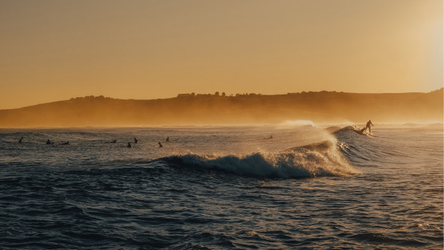 Surfing group wave ocean sunset free wallpaper - medium preview image