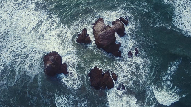 Rocks ocean waves swimmers night free wallpaper - medium preview image