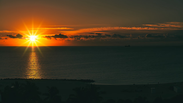 Sunset ocean boat distant lens free wallpaper - medium preview image