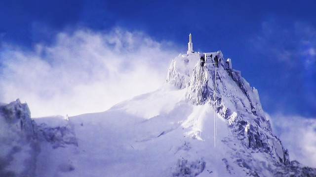 Snowy mountain clocktower zenith view free wallpaper - medium preview image