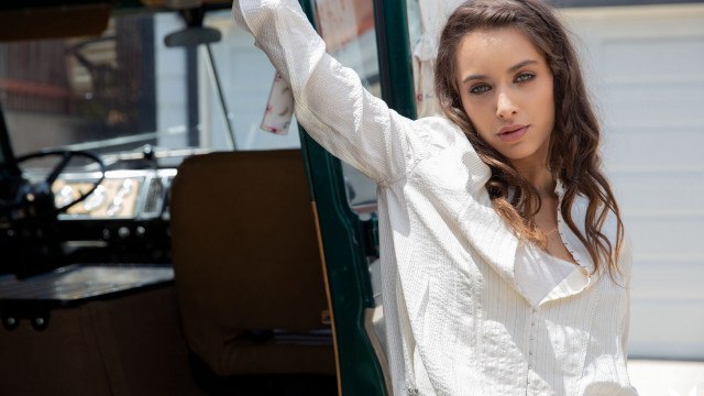 Woman green truck leaning white free wallpaper - medium preview image