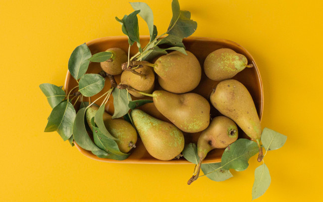 Pear bowl leaves yellow background free wallpaper - medium preview image