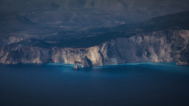 Mountain ocean boat shore sky free wallpaper - medium preview image