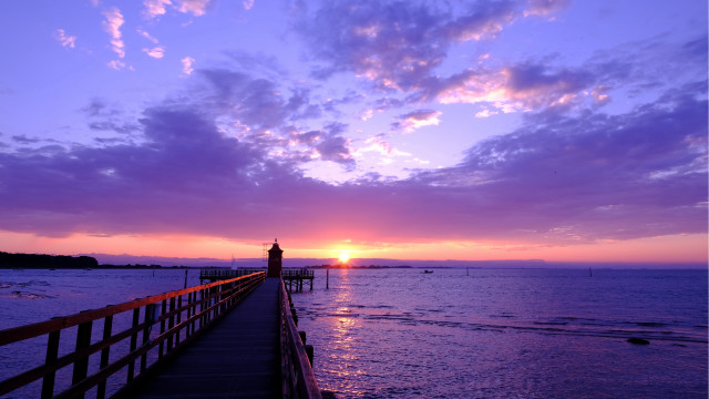 Pier lighthouse sunset clouds water free wallpaper - medium preview image