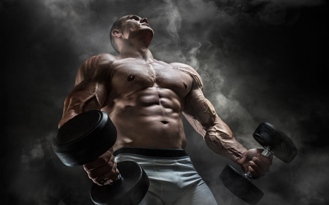 Muscular man dumbbells smokey background free wallpaper - medium preview image