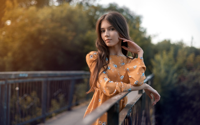 Woman leaning on rail serious free wallpaper - medium preview image