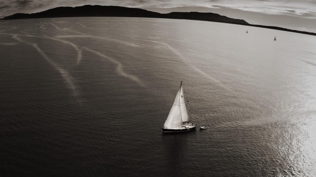 Sailboat mountains ocean clouds blackwhite free wallpaper - medium preview image