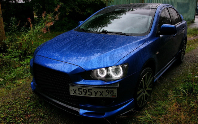 Blue car parked grass road free wallpaper - medium preview image