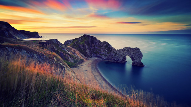 Sunset ocean rock beach landscape free wallpaper - medium preview image