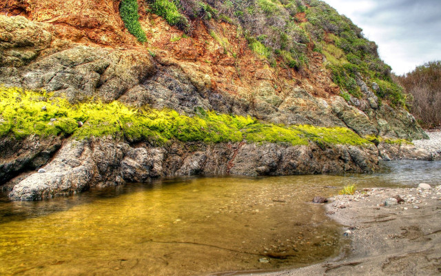 Rocky cliff river grassy area free wallpaper - medium preview image