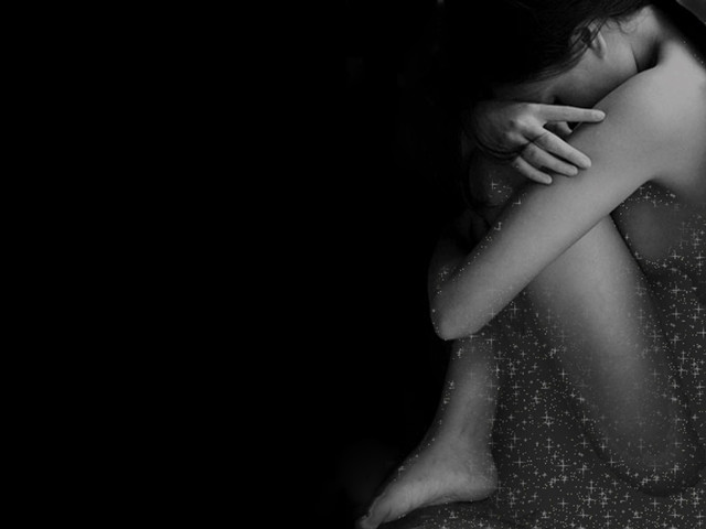 Woman hugging head dark room free wallpaper - medium preview image
