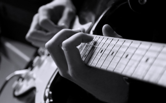 Person playing guitar fingers neck free wallpaper - medium preview image