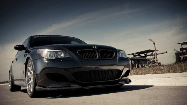 Black car road grass building free wallpaper - medium preview image