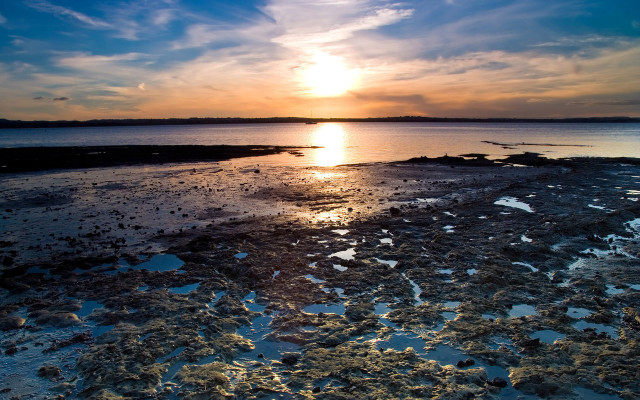 Sunset over water rocky shore free wallpaper - medium preview image