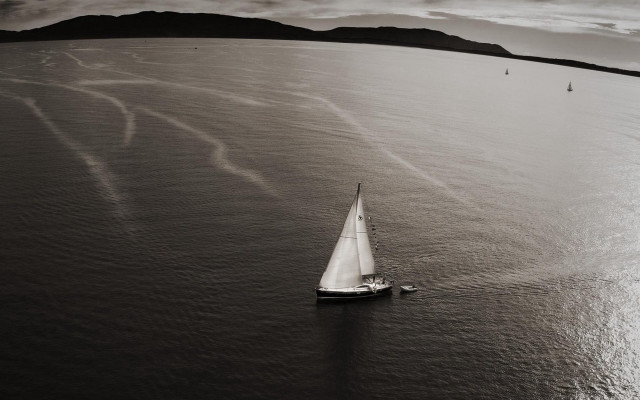 Sailboat mountains beach clouds monochrome free wallpaper - medium preview image