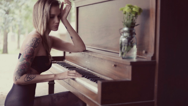 Tattooed woman playing piano flower free wallpaper - medium preview image