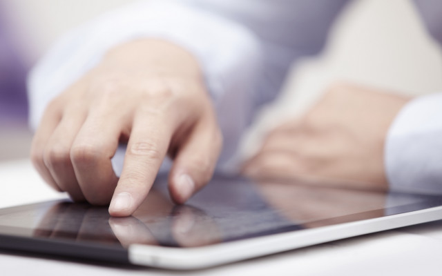 Touching tablet hands blurry background free wallpaper - medium preview image