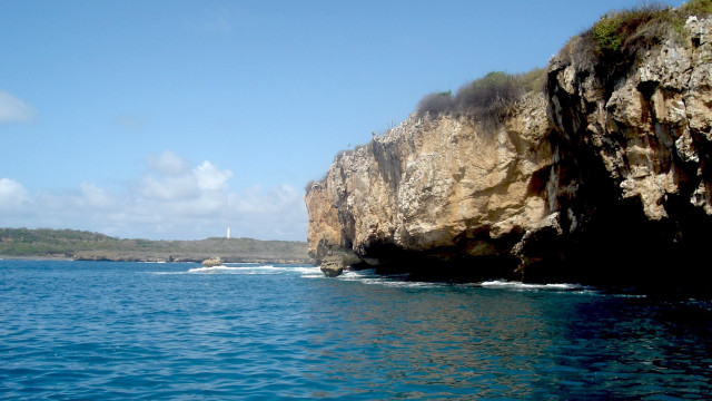 Rocky cliff lighthouse ocean boat free wallpaper - medium preview image