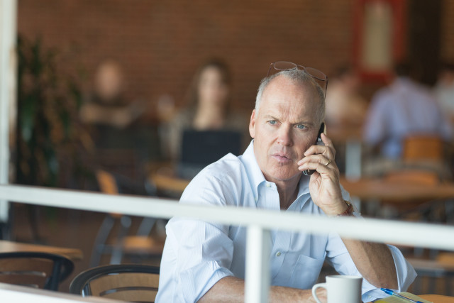 Man sitting table talking cellphone free wallpaper - medium preview image
