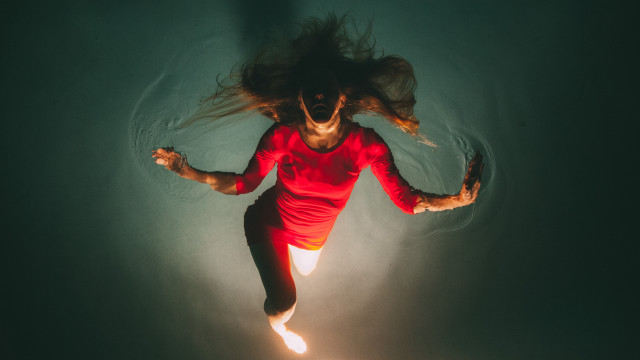 Woman floating water red shirt free wallpaper - medium preview image