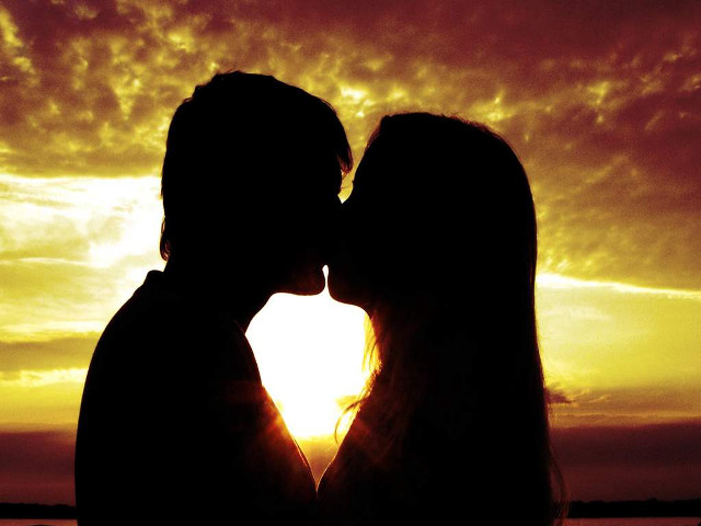 Couple kissing sunset sun clouds free wallpaper - medium preview image