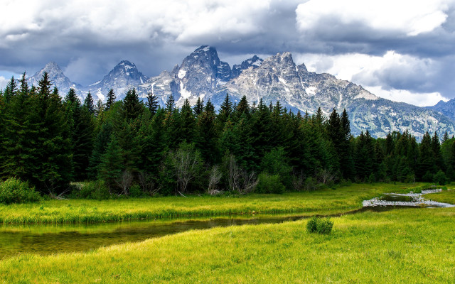 Grassy field stream mountains clouds free wallpaper - medium preview image