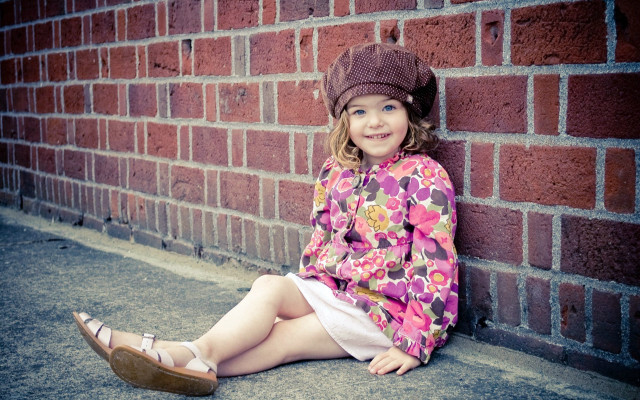Little girl brick wall smiling #2 free wallpaper - medium preview image