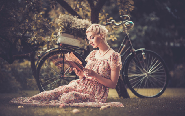 Woman sitting grass reading bicycle free wallpaper - medium preview image