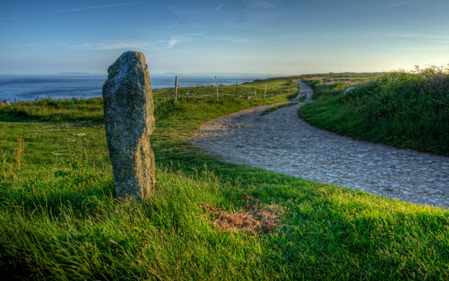 Stone marker grassy path ocean free wallpaper - medium preview image