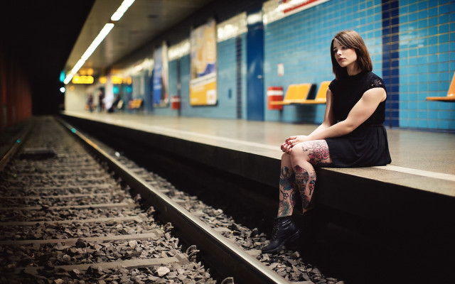 Woman sitting train track portrait free wallpaper - medium preview image