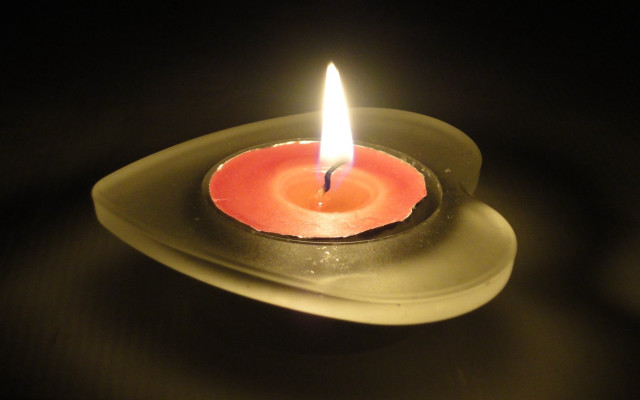 Lit candle plate tabletop black free wallpaper - medium preview image