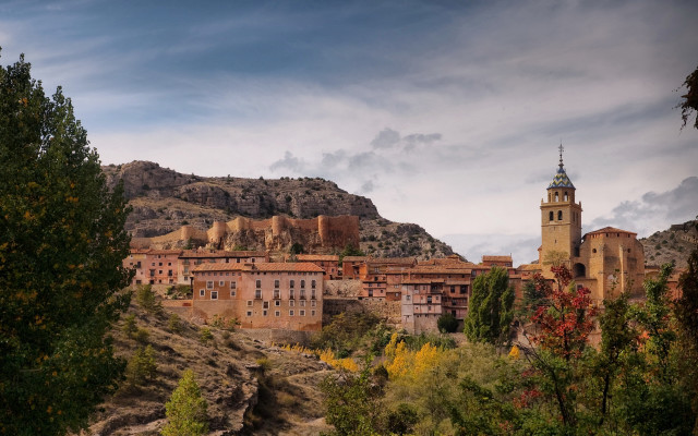 Village clocktower hillside mountains trees free wallpaper - medium preview image