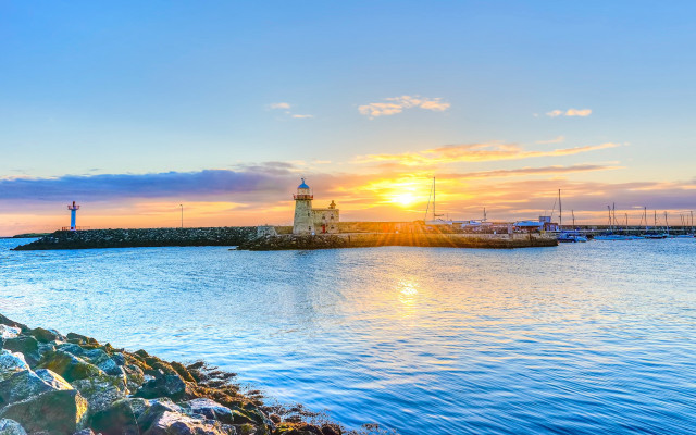 Lighthouse rock outcropping sunset boat free wallpaper - medium preview image