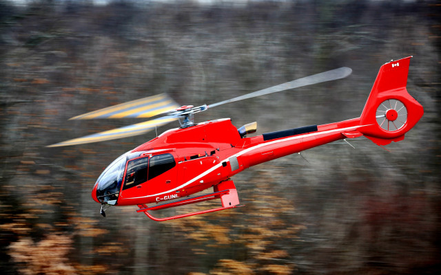 Red helicopter flying over fall free wallpaper - medium preview image